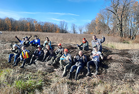 Wetland creation site: staff and volunteer group with newly created woody berm structure in 2022 (Photo Carolyn Davies/NCC)